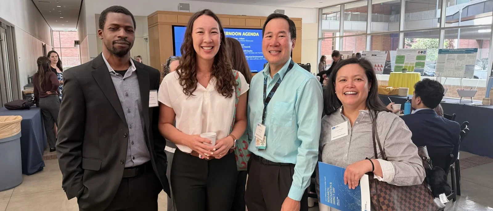 4 people posed smiling at the Research and Impact Day on April 24, 2026