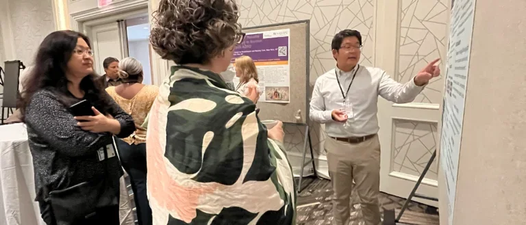 Dr. David Lee is pictured on the right presenting his poster at the RCMAR Annual Meeting in June 2024 in Washington DC