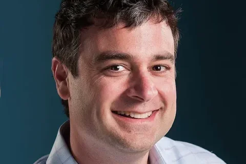 Man's face and shoulders smiling