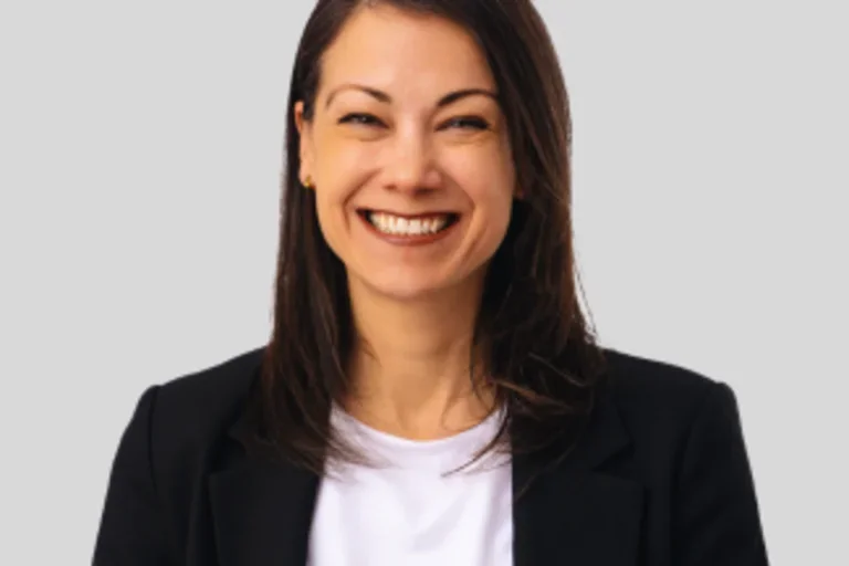 Headshot of Dr. Luisa Blanco with smile wearing a black jacket and white shirt.