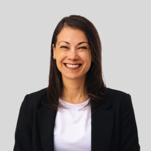 Headshot of Dr. Luisa Blanco with smile wearing a black jacket and white shirt.
