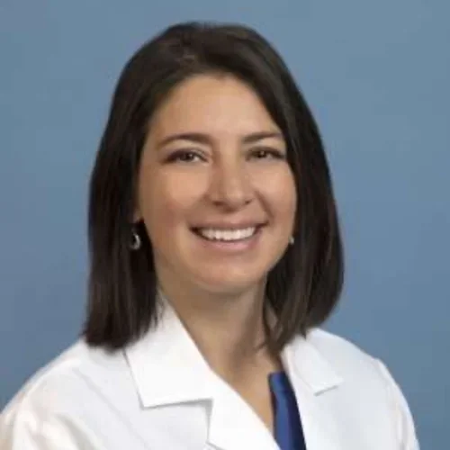 Cecelia Canales is pictured with a while medical coat.