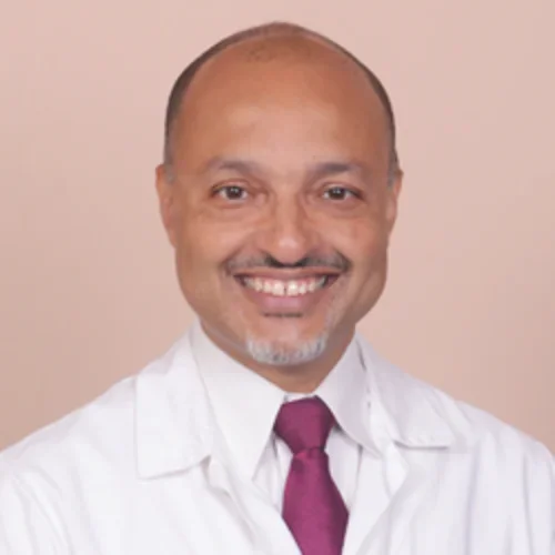 Headshot of Dr. Kenrik Duru in medical coat and red tie