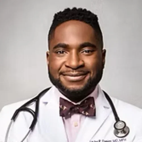 Photo is face of Dr. Utibe Essien, who is a black man with a beard in his medical white coat with a stethescope around his neck.