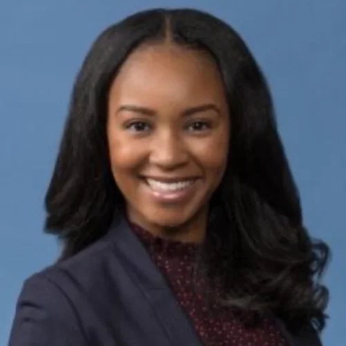 Jennifer Adrissi is a black female pictured with navy blue jacket and maroon shirt