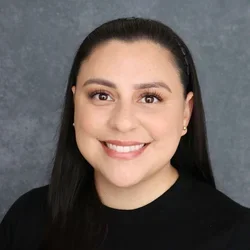 Woman smiling with dark hard and dark shirt
