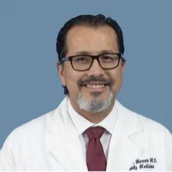 Dr. Gerardo Moreno pictured with glasses, white medical coat and red tie