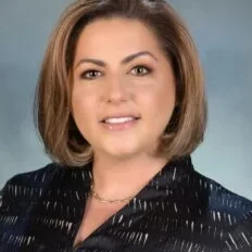 Pictured is Dr. Helen Ovsepyan who is female with short brown hair in a black jacket.