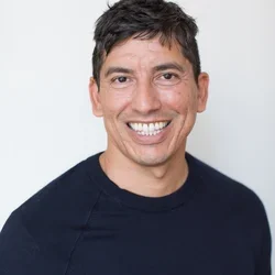 Peter Ureste is pictured here in a black shirt smiling