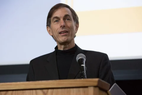 Steven Wallace talking at a podium.
